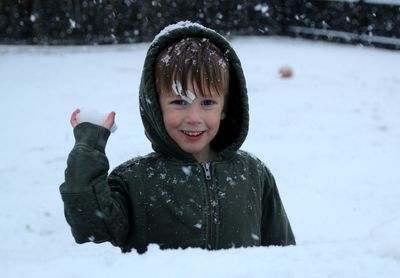 Portrait of smiling boy in snow