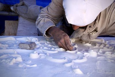 Midsection of man making a mold