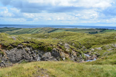 Scenic view of landscape and sea against sky