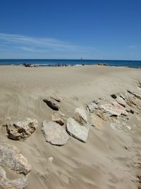 Scenic view of beach against clear blue sky