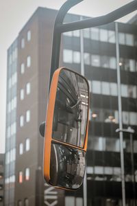 Low angle view of telephone booth against building