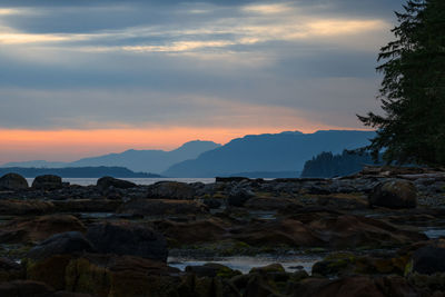 Scenic view of rocks against sky during sunset