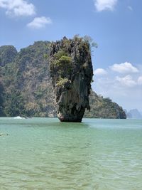 Scenic view of rock formation in sea against sky