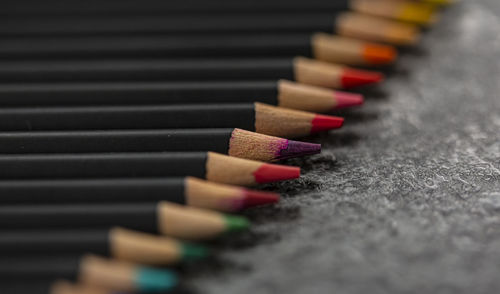 Close-up of multi colored pencils on table