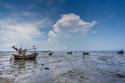 Fishing boats on sea against sky