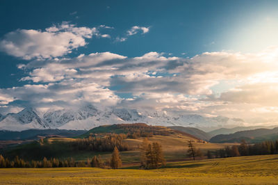 Scenic view of snowcapped mountains against cloudy sky