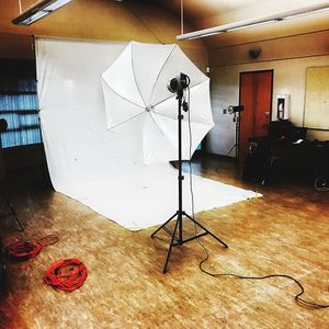 Reflection of man photographing on floor in sunlight