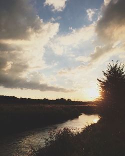 Scenic view of lake against cloudy sky