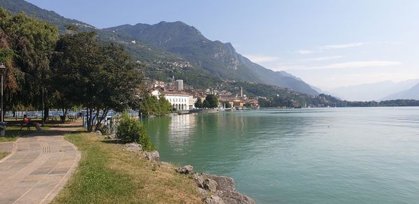 Scenic view of lake by buildings against sky