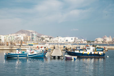 Boats moored on sea against sky