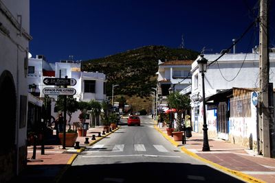 City street and buildings against sky