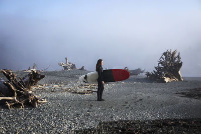 Beautiful, fit surfer girl in the pacific northwest