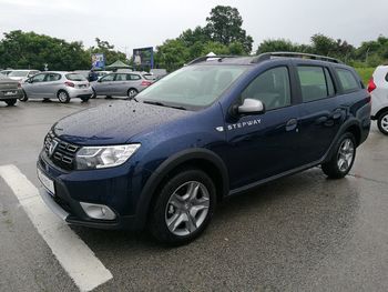 Car parked on road against sky in city