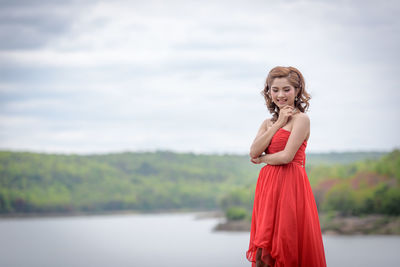 Portrait of a smiling young woman standing outdoors
