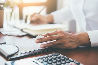 Cropped image of man working on table