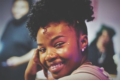 Close-up portrait of a smiling young woman