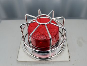 Detailed close up view on metal and steel surfaces with a red lamp