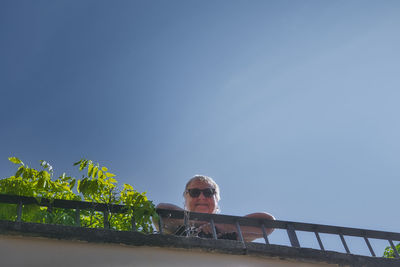 Low angle portrait of man against sky