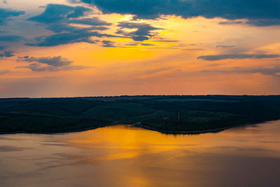 Scenic view of river against orange sky