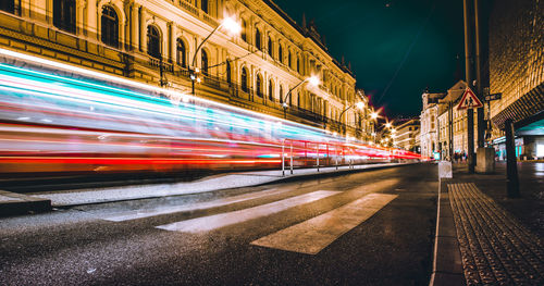 Blurred motion of cable car on city street at night