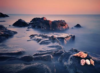 Scenic view of sea against sky at sunset