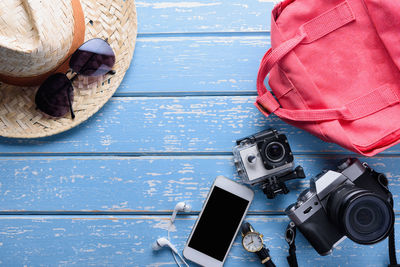 Directly above shot of technologies and personal accessories on table