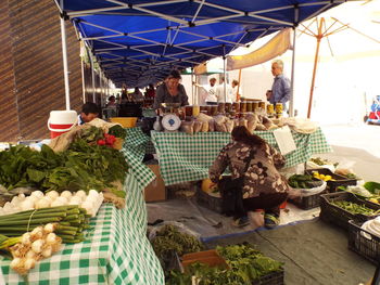 Group of people for sale at market stall