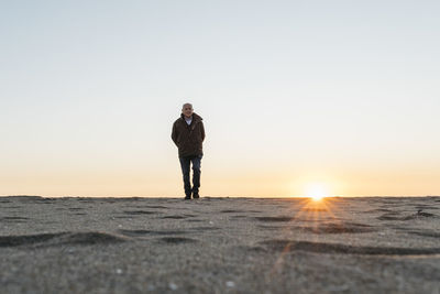 Senior man strolling at the beach