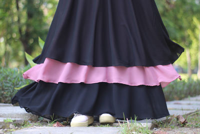 Low section of woman standing on ground