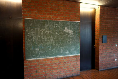 Graffiti on brick wall of building