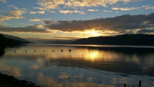 Scenic view of lake against sky during sunset