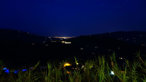 Scenic view of illuminated field against clear sky at night