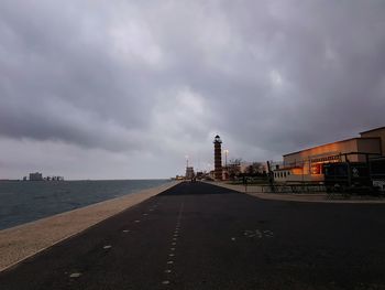 Road by sea against sky