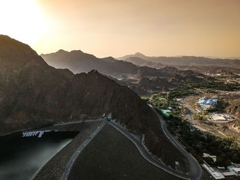 Road by mountains against sky during sunset. hatta dam, uae