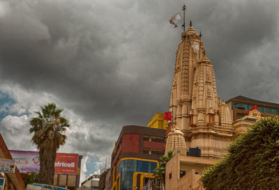 Low angle view of clock tower against sky in city