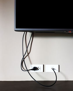 Cropped image of television set mounted on wall