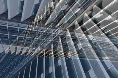 Double exposure of modern building against blue sky