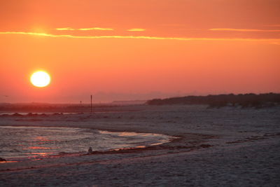 Scenic view of sea against orange sky