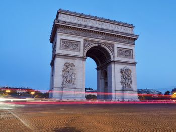 Arc de triomphe against clear sky at dusk