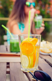 Woman having orange juice in restaurant