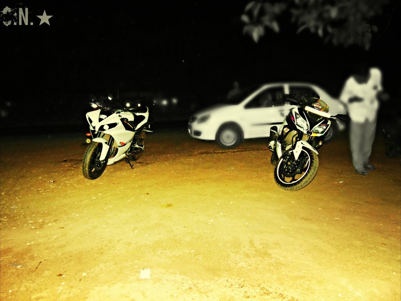 bicycle, transportation, land vehicle, mode of transport, parked, stationary, parking, street, road, shadow, outdoors, sunlight, night, absence, sand, no people, riding, car, high angle view