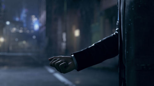 Cropped hand of person holding illuminated light