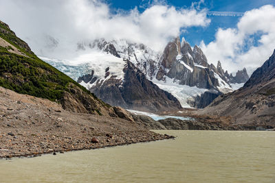 Scenic view of mountains against cloudy sky