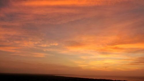 Scenic view of dramatic sky over sea during sunset