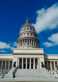 Low angle view of building against cloudy sky