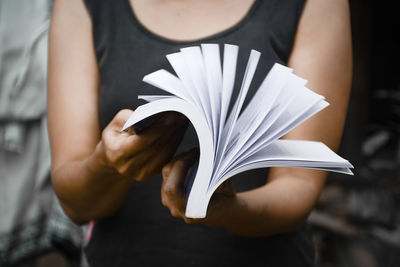 Close-up of hand holding book
