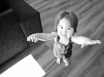 Portrait of cute baby girl on floor at home