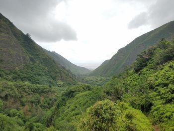 Scenic view of mountains against cloudy sky