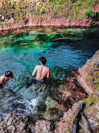 High angle view of men swimming in water