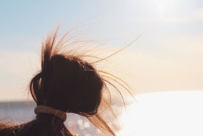 Rear view of woman against sky